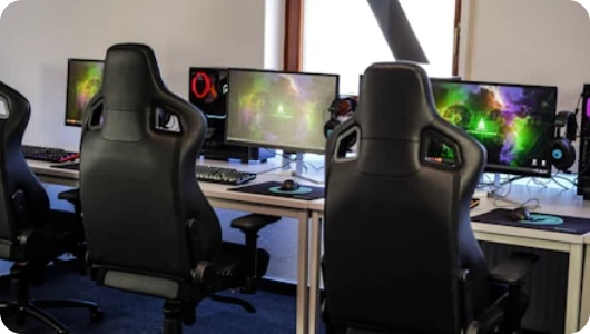 Gaming room with chairs and desktop computers